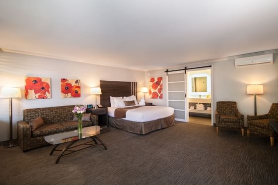 bed in spacious hotel room with couch
