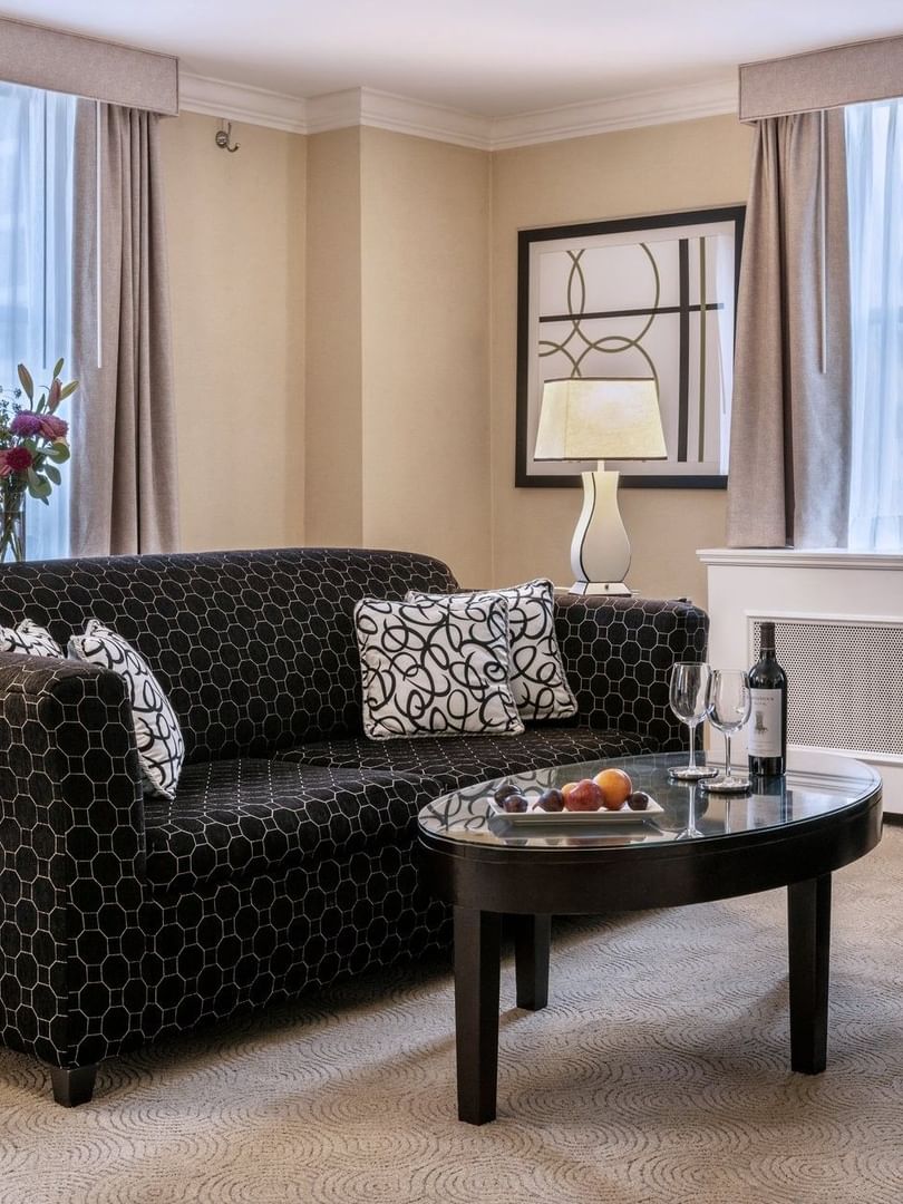 Patterned sofa with coffee table near window in Specialty Suite at Warwick Allerton Chicago