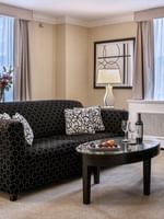 Patterned sofa with coffee table near window in Specialty Suite at Warwick Allerton Chicago