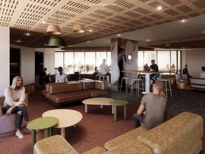 Modern lobby design with people sitting on couches and tables at UniLodge Brisbane City.
