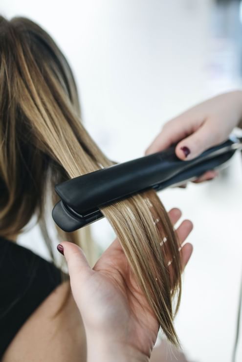 A girl straightening the hair in a salon at Hotel Berlin Berlin