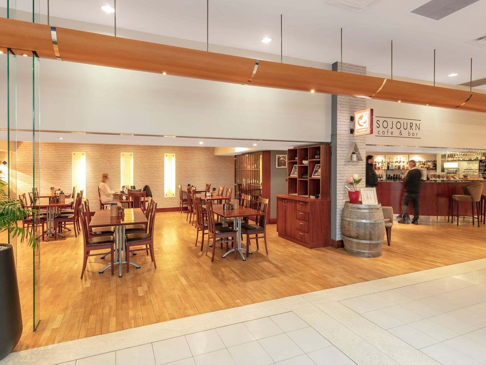 Dining & lounge area in Sojourn Restaurant & Bar with wooden interior at James Cook Hotel