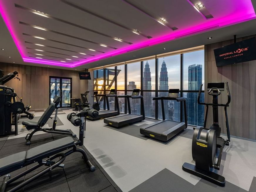 O2 Gym with tread machines and cityscape view at Imperial Lexis, fitness center in KL