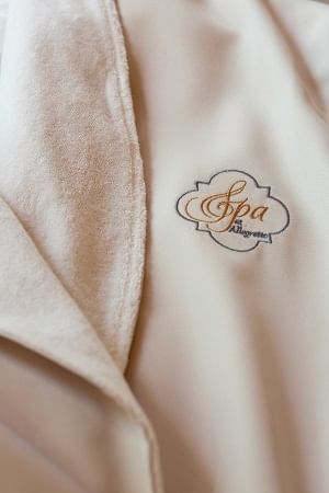 Spa at Allegretto Vineyard Resort Paso Robles logo on a white robe 