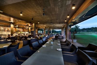 Golfer's Terrace at The Saujana Hotel Kuala Lumpur with wicker seating, modern lighting, and golf course views