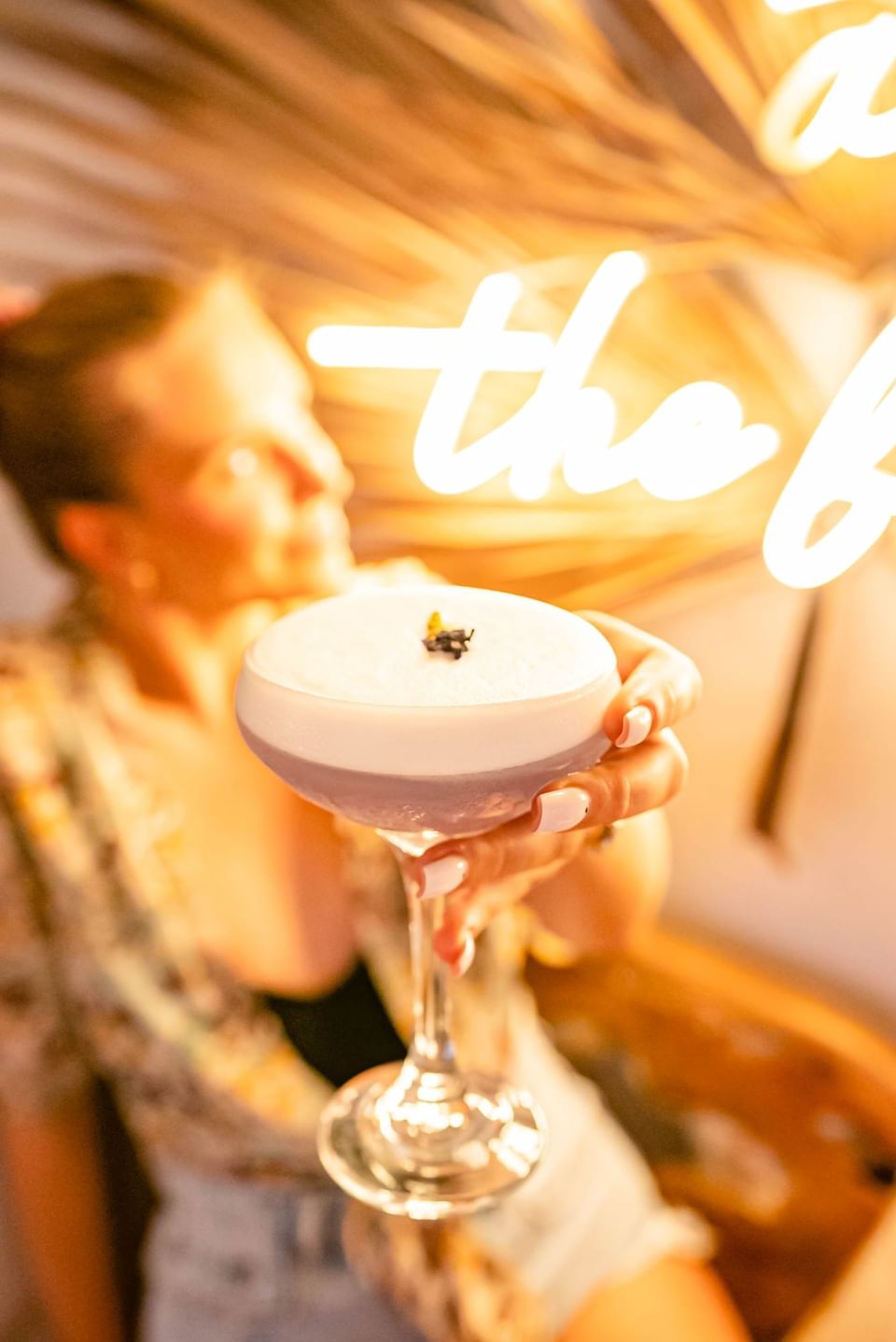 A woman posing with a cocktail glass at Bougainvillea Barbados