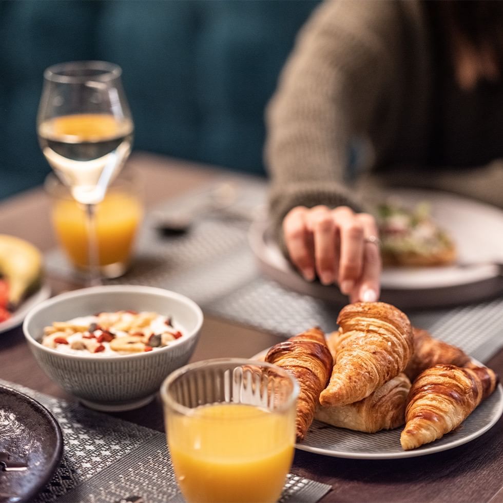 Breakfast meal with croissants, fruit bowl and juice served at Falkensteiner Hotel Prague