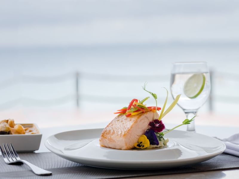 Close-up of salmon dish served at FA Hotels & Resorts