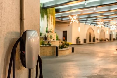 Tesla charging station mounted on a wall in a parking garage at The Riverwalk Plaza Hotel