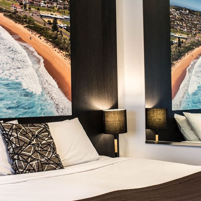 Interior view of beds and wall pictures of a room at Mercure Gerringong