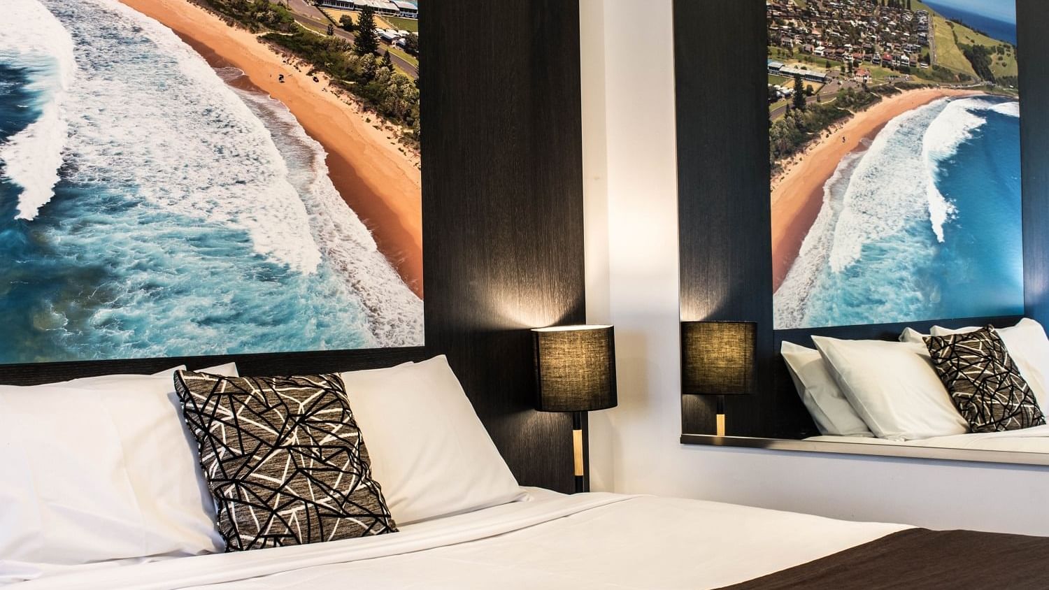 Interior view of beds and wall pictures of a room at Mercure Gerringong