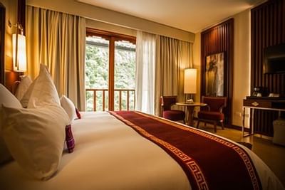 Close up on the king bed in a room at Hotel Sumaq