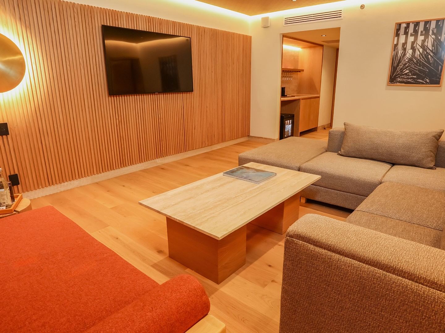 Cozy living area with wooden floors, furniture, and flat screen TV at Camino Real Polanco Mexico in Ciudad de Mexico.