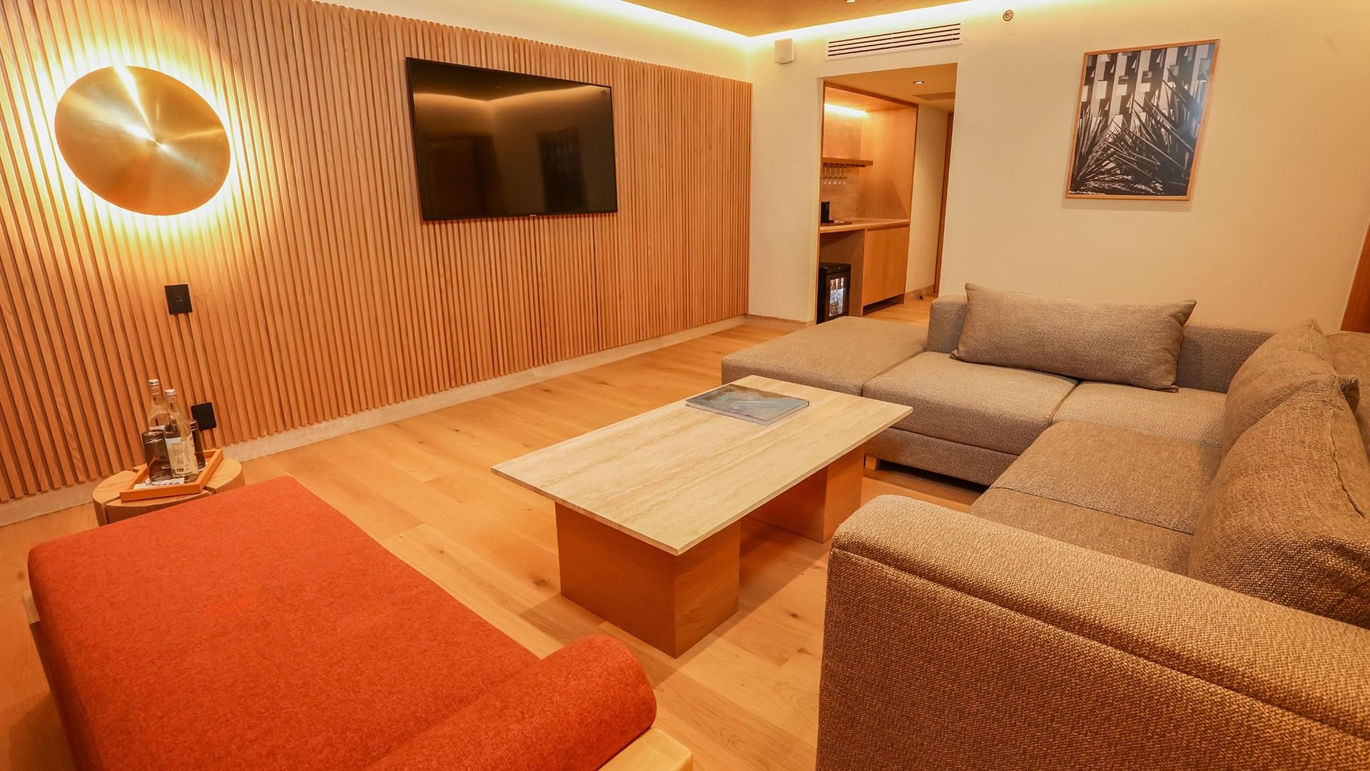 Cozy living area with wooden floors, furniture, and flat screen TV at Camino Real Polanco Mexico in Ciudad de Mexico.