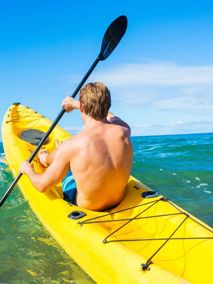 A man rowing boat in the sea near The lodge 30A