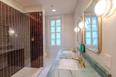 Bathroom with vanity and shower area in Grand King Suite at The Ashbrook Hotel, one of the best hotels in Kentucky