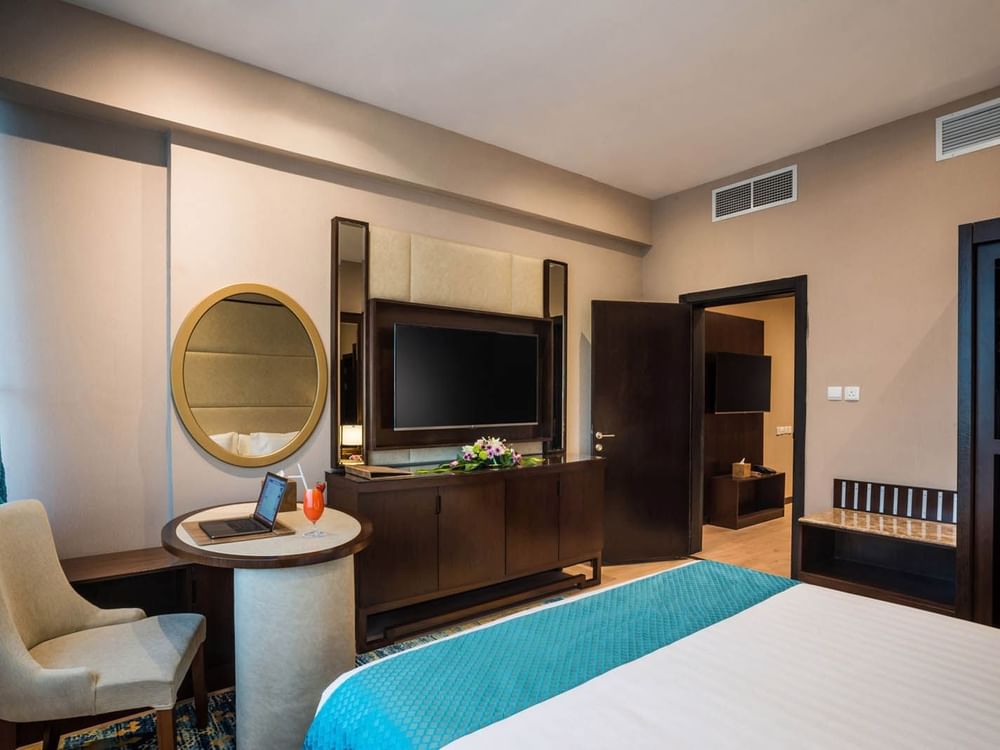 TV facing bed with work desk in Junior Suite at Naviti By Warwick Dammam