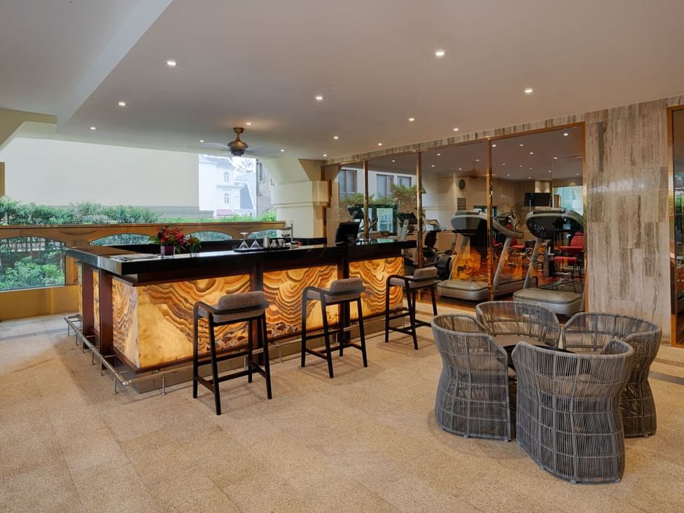 bar counter with three cushion high chairs