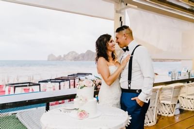 Couple in front of cake at Cabo Villas Beach Resort