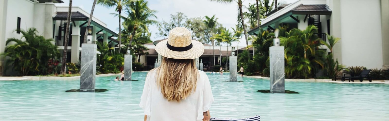 A girl enjoying the pool view at pullman port douglas sea temple resort and spa