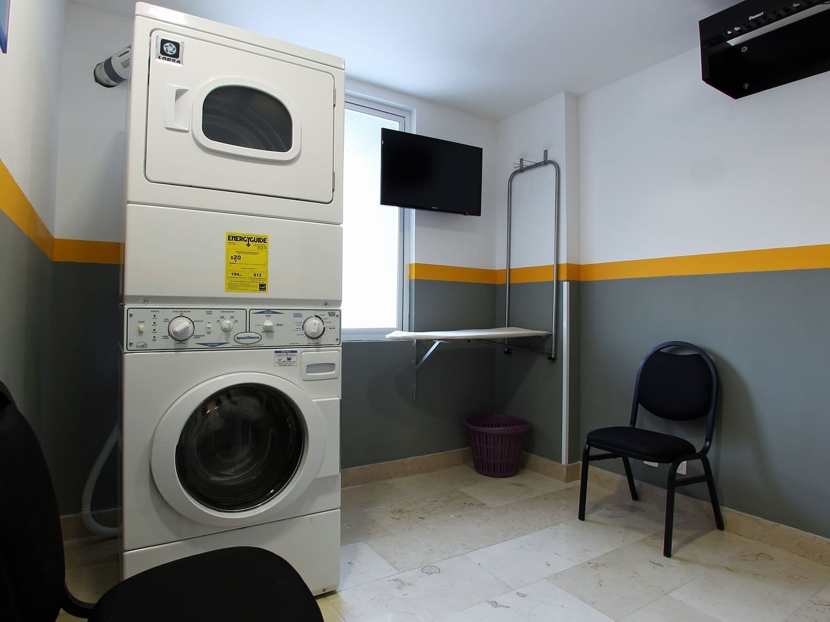 Washing machine & a clothes iron in a laundry room, One Hotels