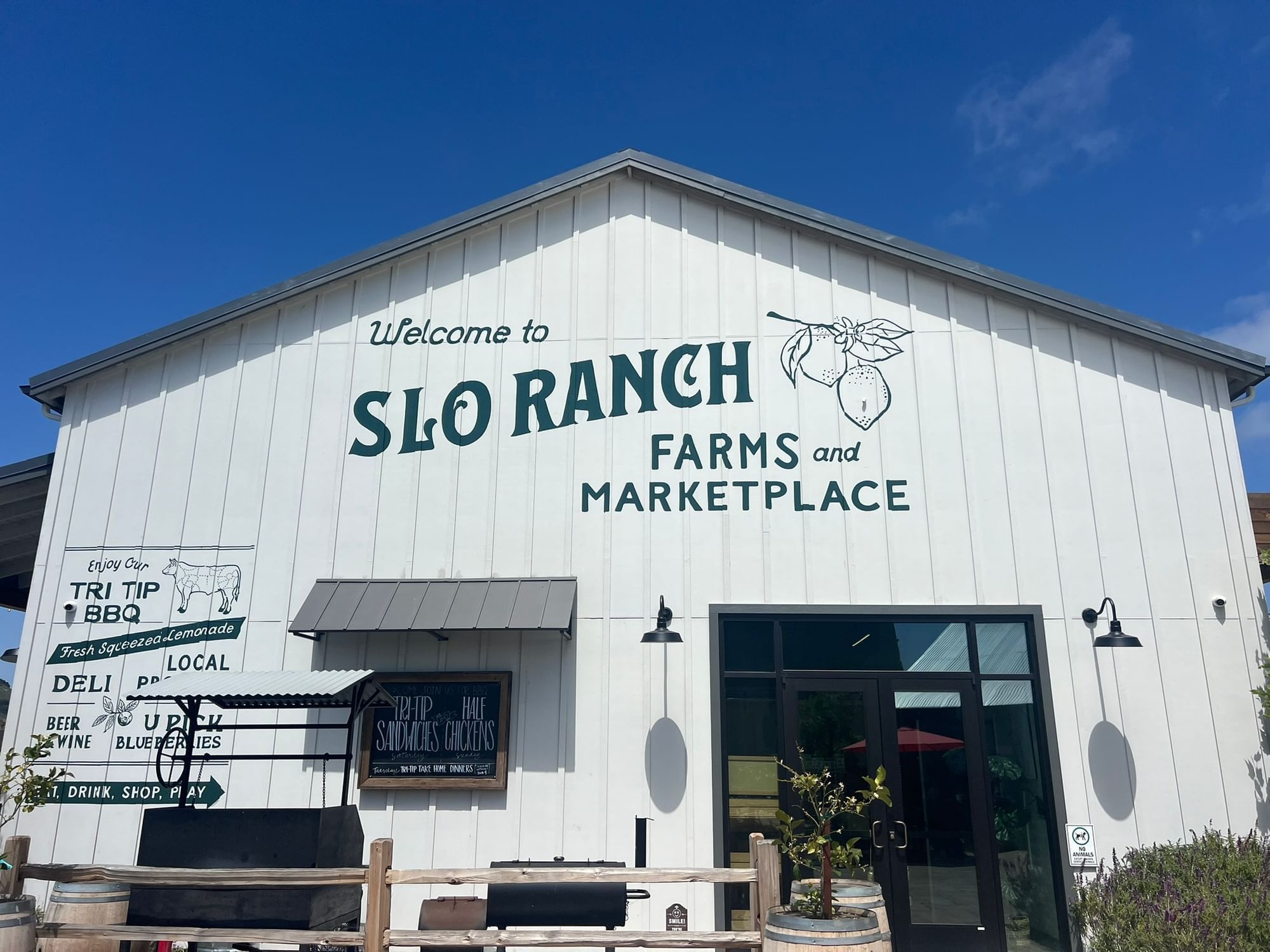 SLO Ranch Farms and Marketplace exterior sign on a white barn