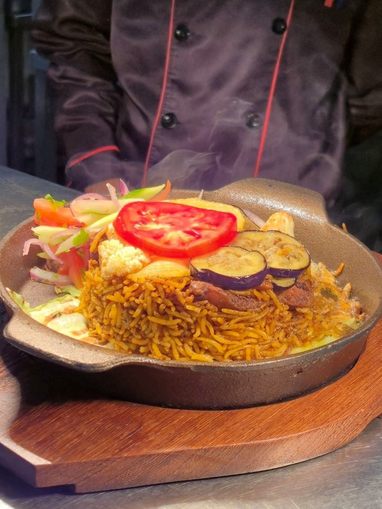 Steaming dish of rice, veggies, and meat at Zanzibar Serena Hotel's Baharia Restaurant.