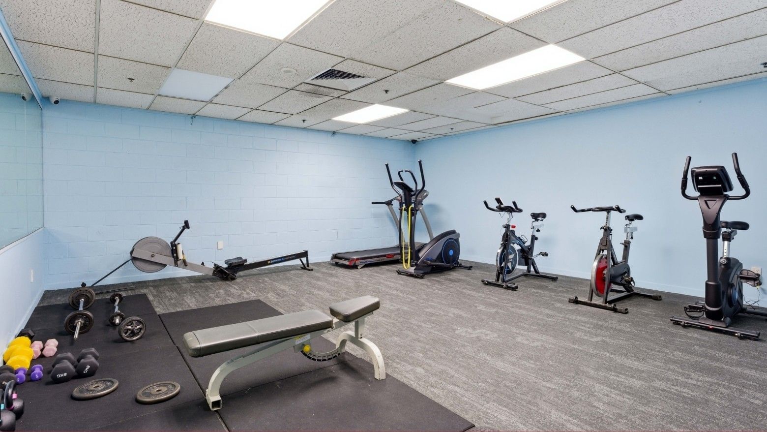 Fitness room with various equipment and mats at UniLodge Stafford House.
