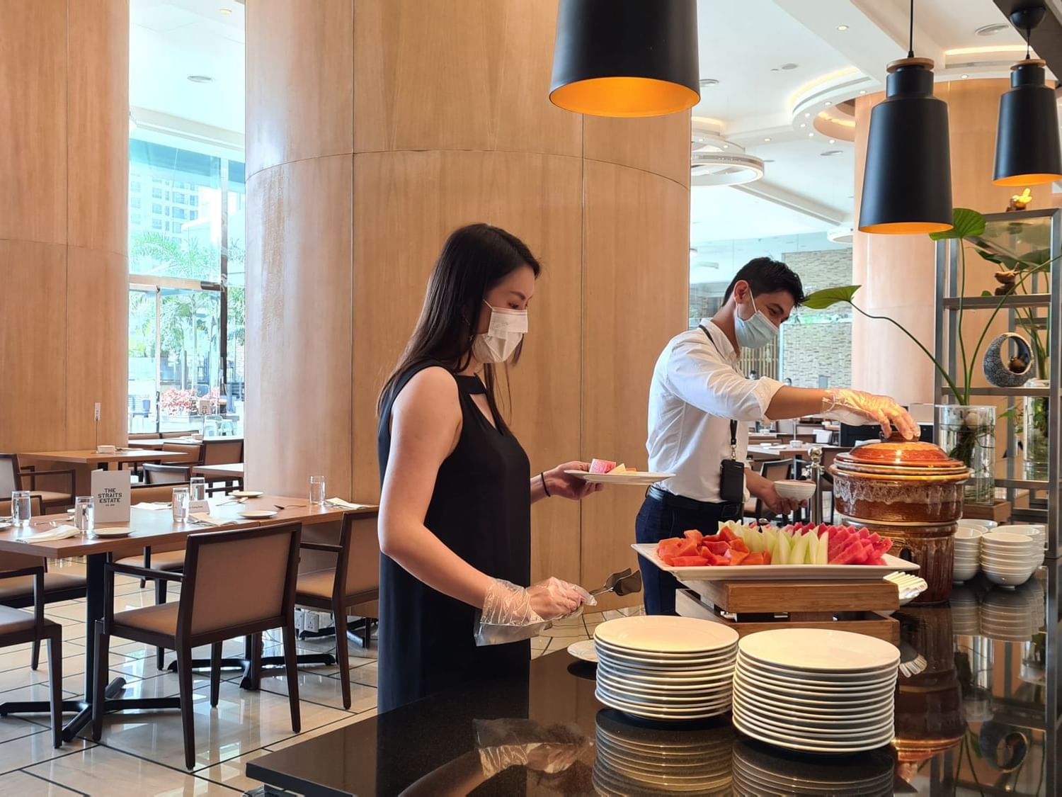 2 guests serving themselves by buffet at VE Hotel & Residence