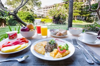 Morning breakfast with fruits, pastries & beverages served in the garden at Irazu Hotel