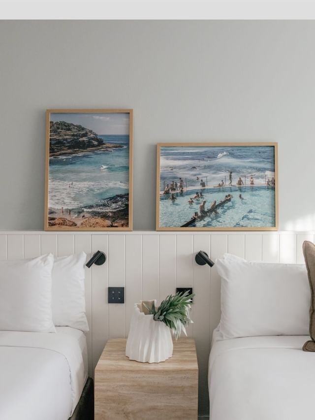 Village Terrace Twin at Elysium Manly with olive cushions under framed ocean photography beside a stone nightstand and vase