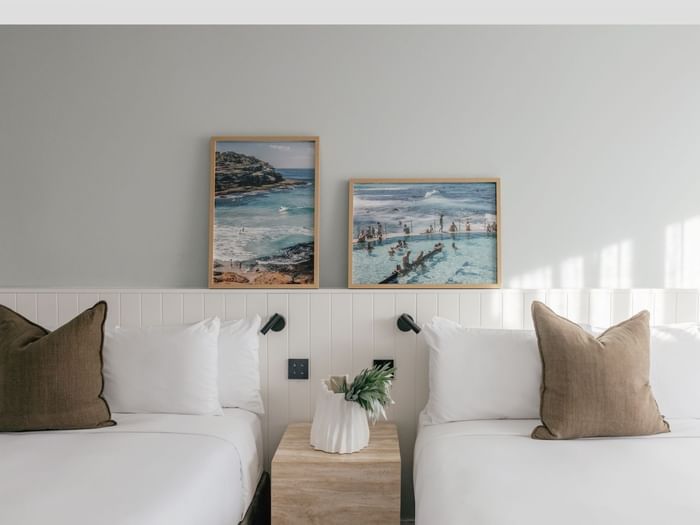 Village Terrace Twin at Elysium Manly with olive cushions under framed ocean photography beside a stone nightstand and vase
