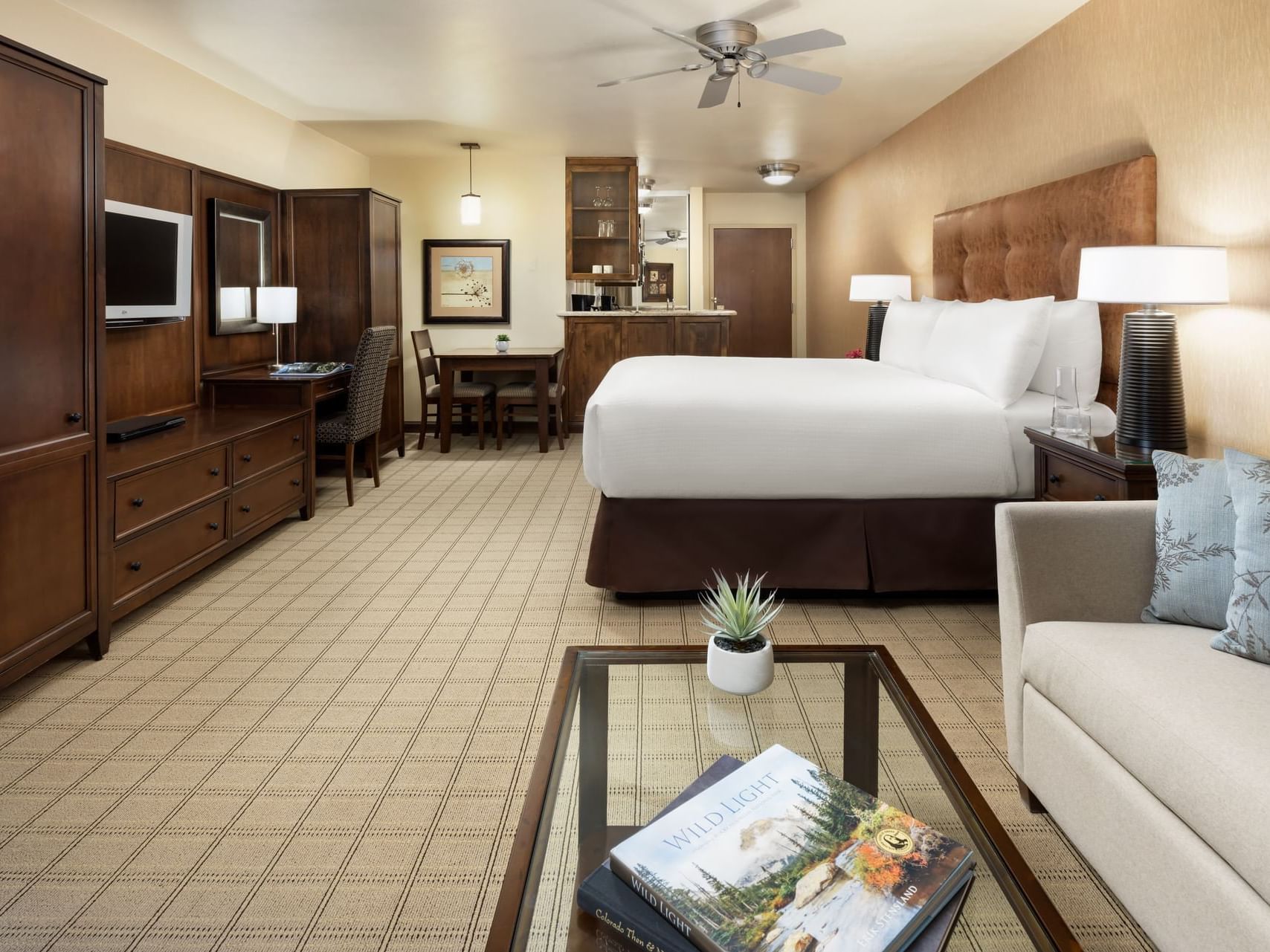 Standard King room with a large bed, couch, and coffee table at Elevation Hotel & Spa.