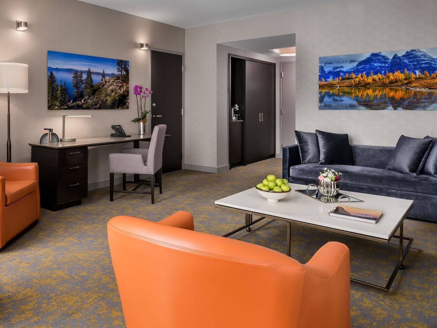 Seating area with workspace and artwork on the wall in One Bedroom Suite at Hotel X Toronto