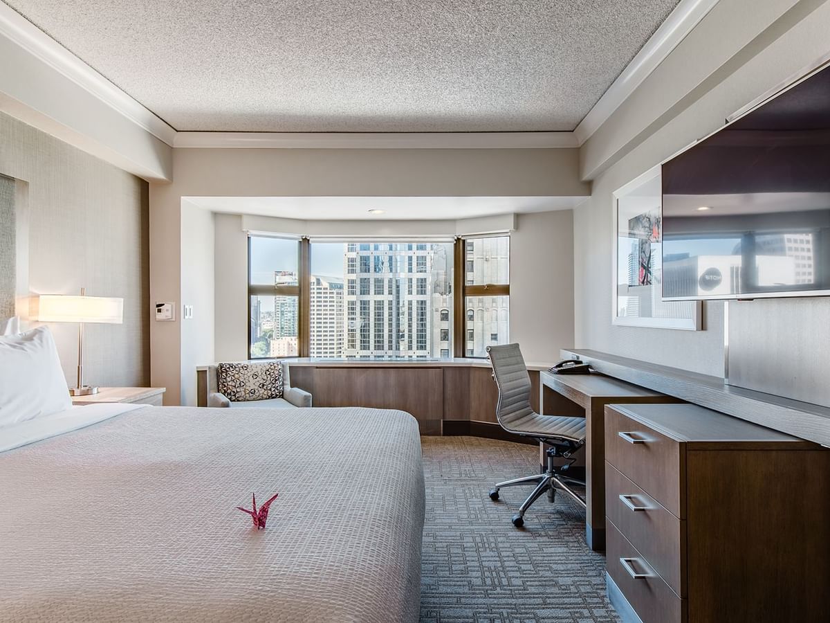 Accessible hotel guestroom with king bed, TV, and desk