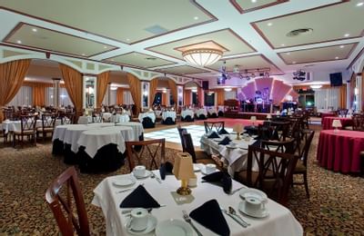 Event space set with tables and dance floor.