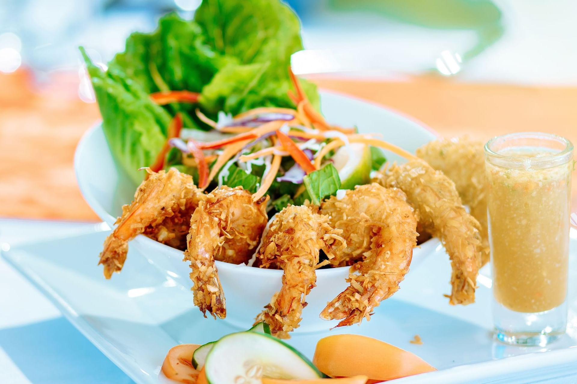 Crispy coconut shrimp served with a fresh salad and dipping sauce at Bay Gardens Hotels and Resorts