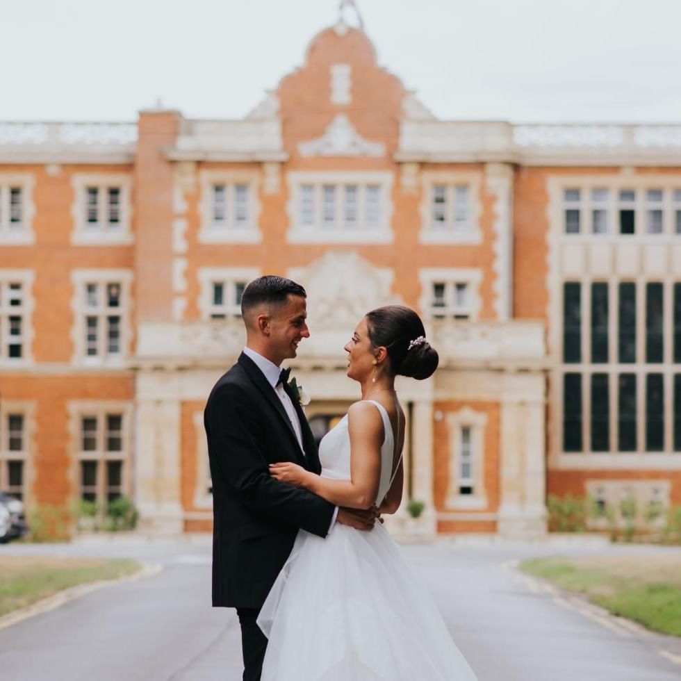 Married couple outside of Easthampstead Park Hotel in Berkshire