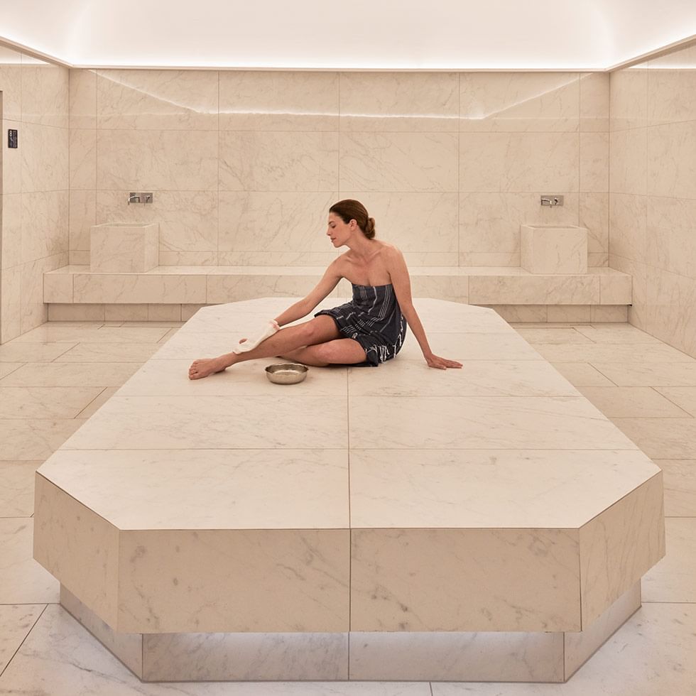 A woman sitting in Acquapura spa at Falkensteiner Hotels
