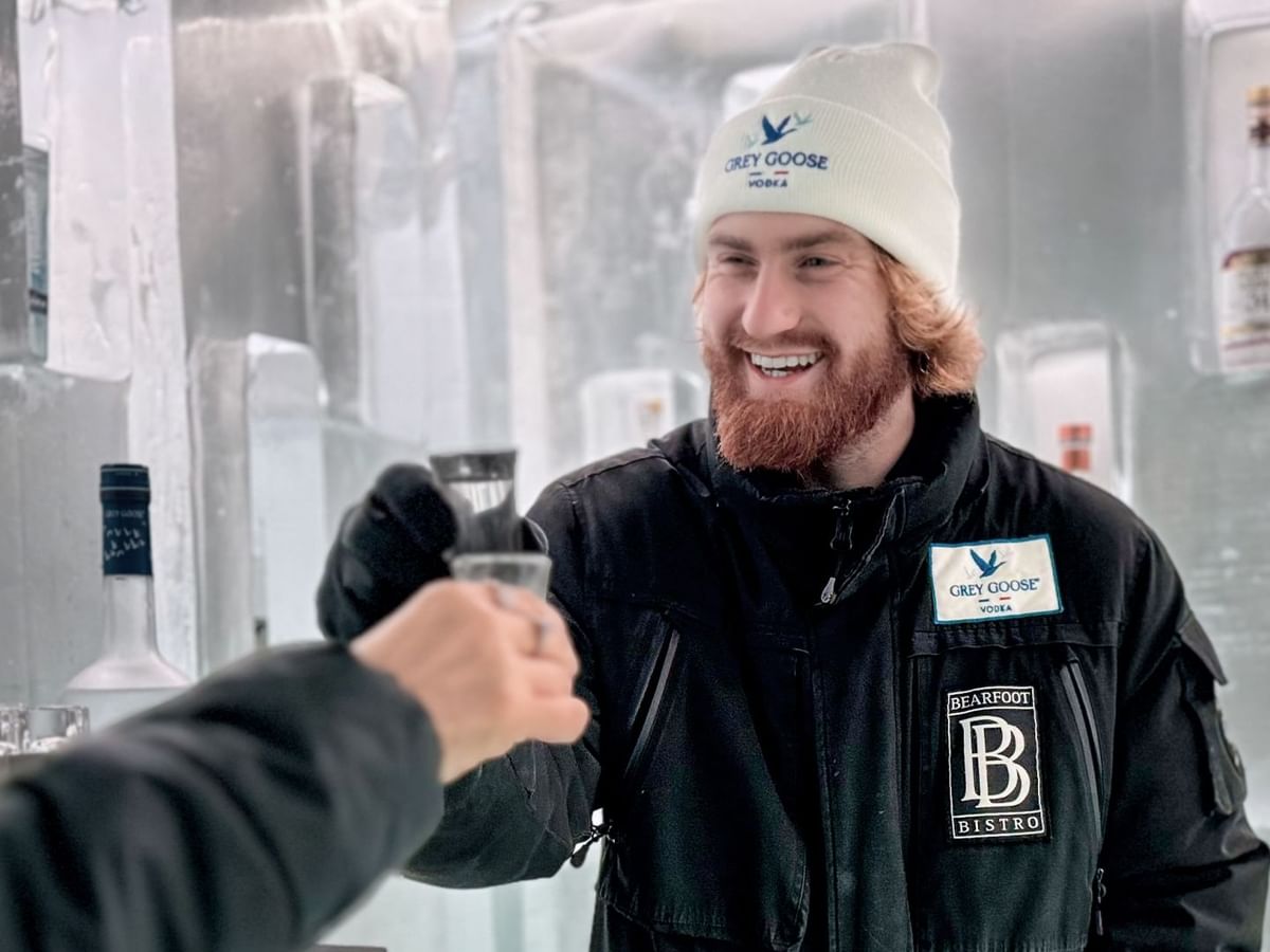 Bartender serving vodka inside the Grey Goose Ice Room