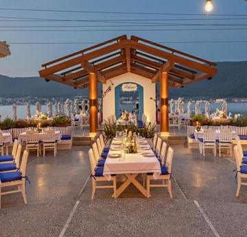 Elegant outdoor seating with dining tables at Yamas À la Carte Restaurant, Titanic Luxury Collection Bodrum