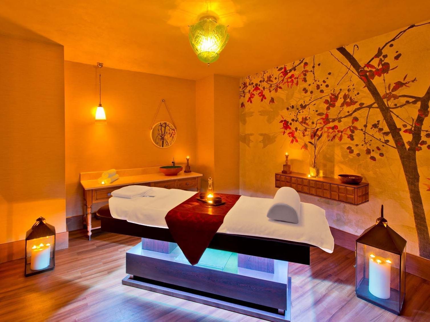 Herbal oils spotted on a massage bed with towels in BeFine Spa at Titanic Deluxe Lara