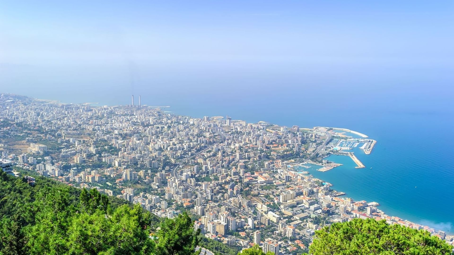 Panoramic city view by the blue sea under a clear sky near the Warwick Palm Beach Hotel