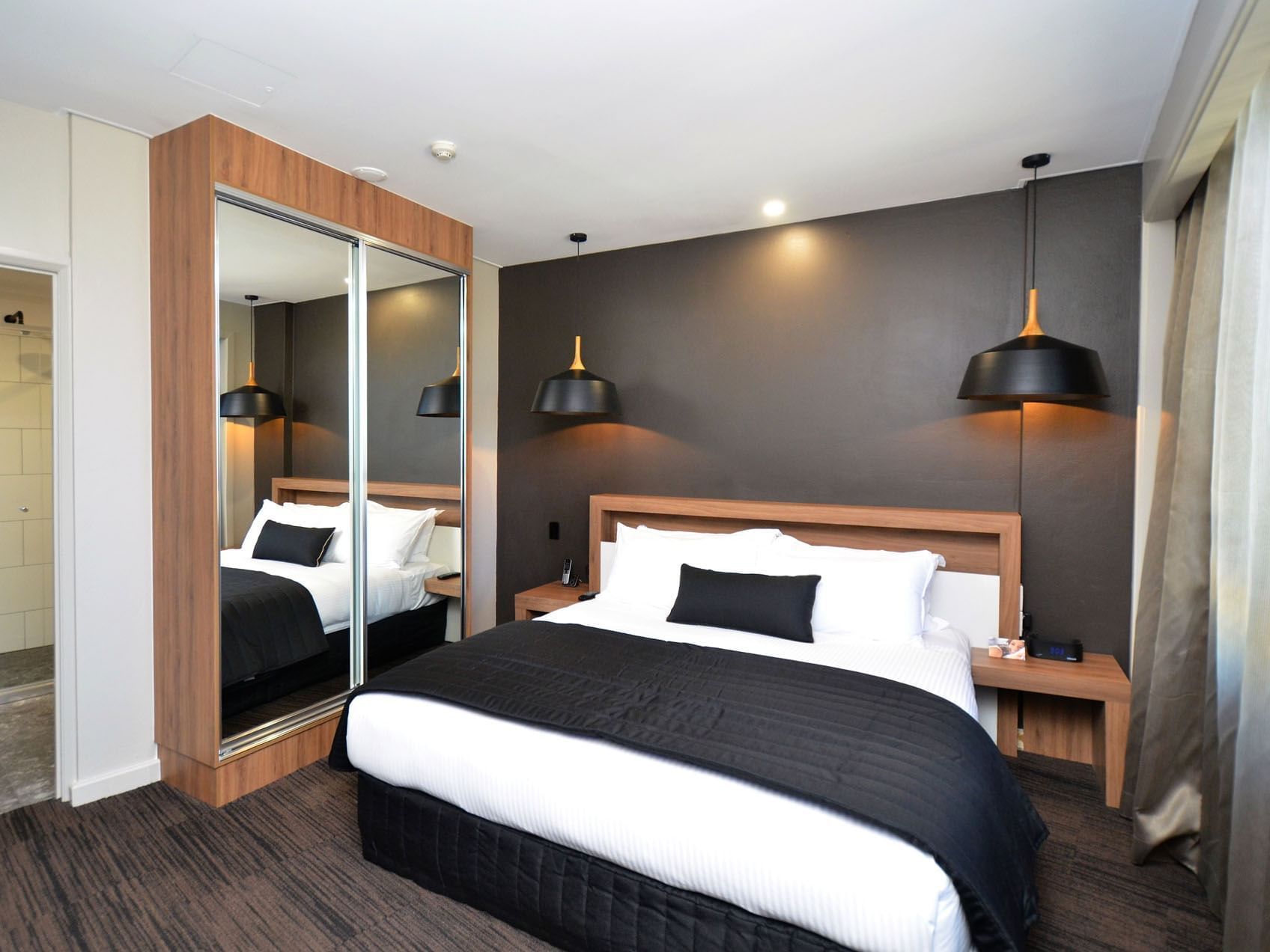 Closet with mirrors in Executive Suite at Grand Chancellor Townsville