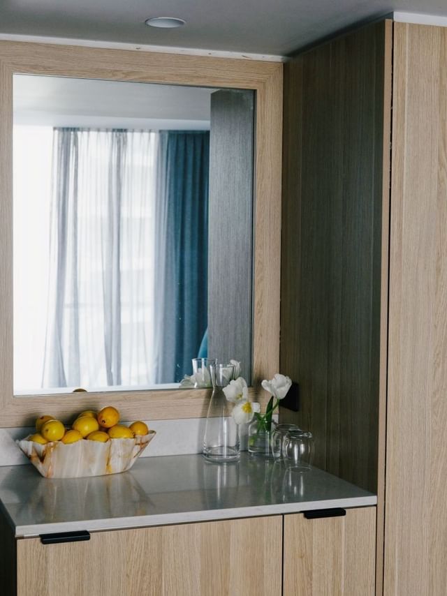 Village Balcony Queen at Elysium Manly with a shell bowl of lemons by tulip vases, a top choice for Manly accommodation