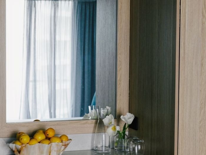 Village Balcony Queen at Elysium Manly with a shell bowl of lemons by tulip vases, a top choice for Manly accommodation
