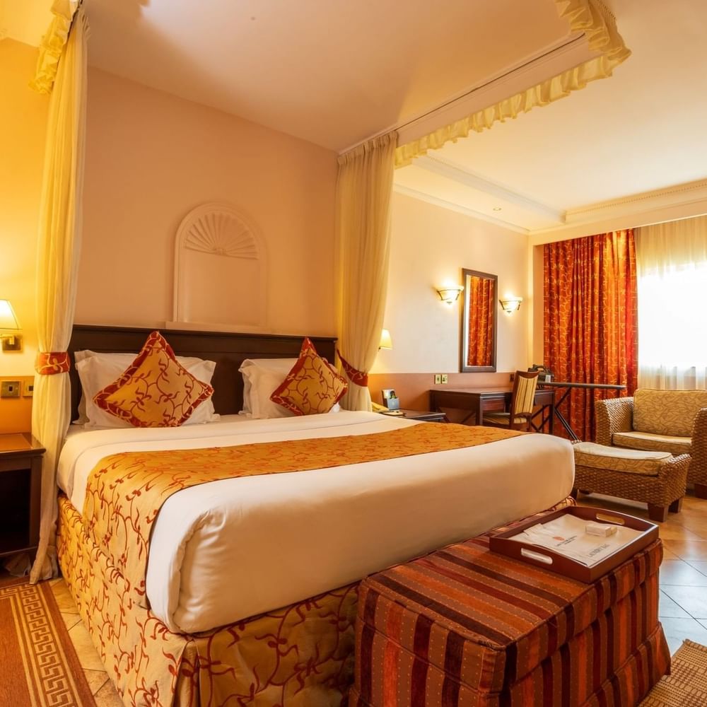 Elegant Executive Suite bedroom at Lake Victoria Serena Golf Resort & Spa in Kampala.