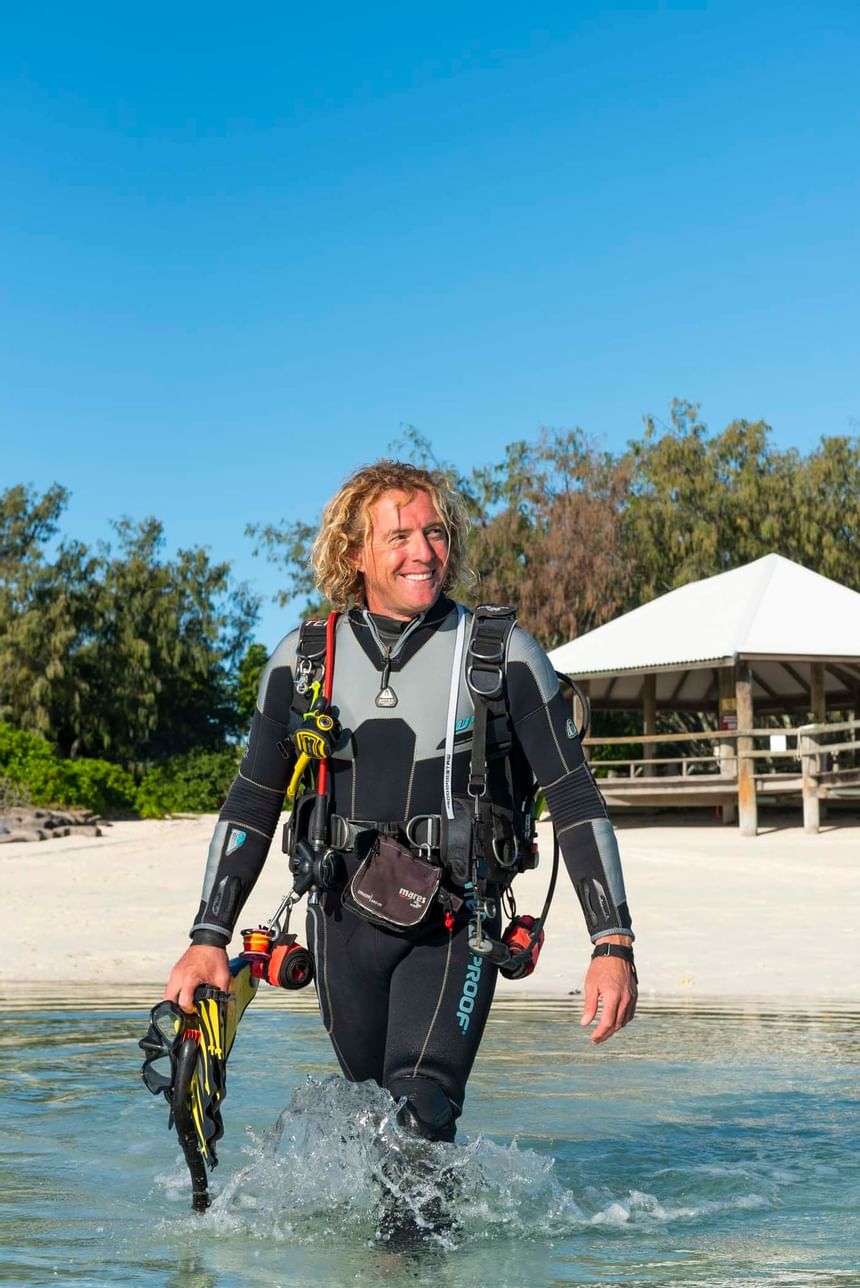 A diver walking into the sea near Heron Island Resort