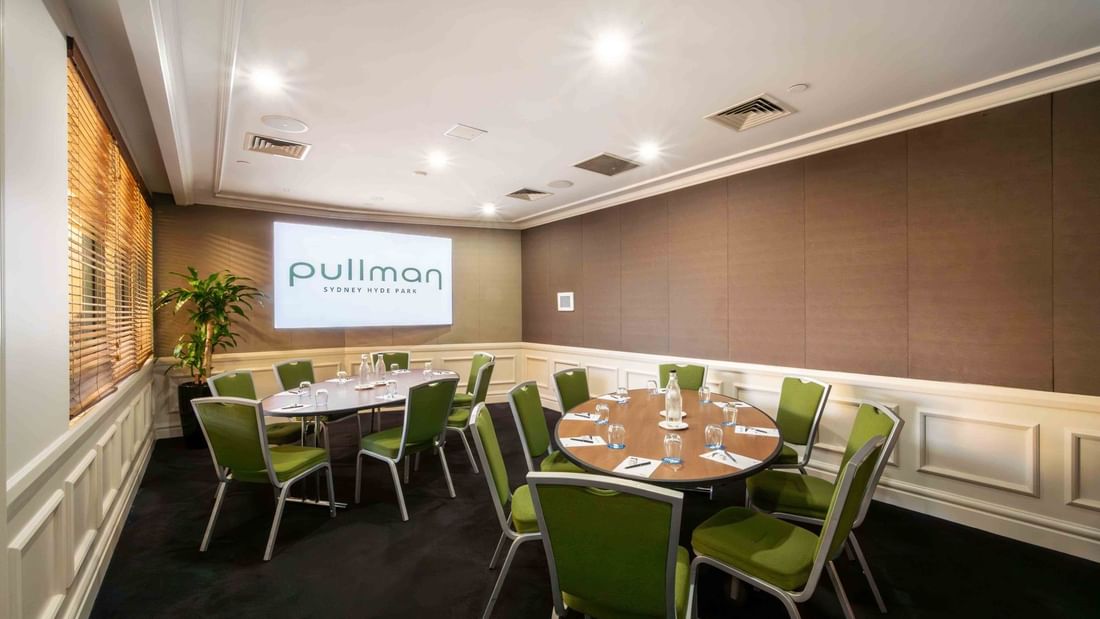 Banquet set-up with projector screen in Dalley Room at Pullman Sydney Hyde Park