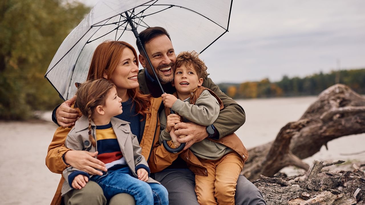 family of four under umbrella